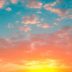 A serene sunset sky painted with a palette of warm oranges gentle pinks and tranquil blues dotted with fluffy cotton-like clouds.
