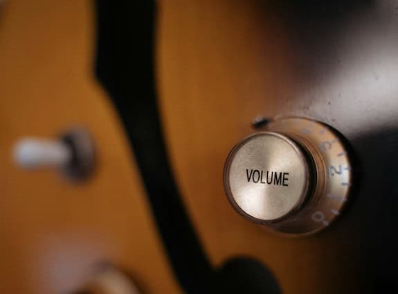 Photo of a volume knob on an electric guitar.